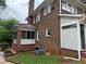 Brick home's exterior showing a screened porch, red roof, and well-maintained lawn at 1098 Oakdale Ne Rd, Atlanta, GA 30307