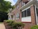 Home's brick exterior with a screened porch, white columns, and manicured landscaping at 1098 Oakdale Ne Rd, Atlanta, GA 30307