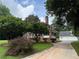 Home exterior with brick, a red roof, mature trees, and a long driveway at 1098 Oakdale Ne Rd, Atlanta, GA 30307