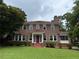 Beautiful two-story brick home with a tile roof and green lawn at 1098 Oakdale Ne Rd, Atlanta, GA 30307