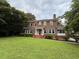 Brick two-story home with a well manicured lawn and mature trees at 1098 Oakdale Ne Rd, Atlanta, GA 30307