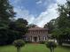 Charming two-story brick home with a red tile roof and well-manicured lawn at 1098 Oakdale Ne Rd, Atlanta, GA 30307