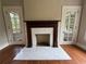 Living room fireplace with marble surround and dark wood mantle flanked by doors to the outside at 1098 Oakdale Ne Rd, Atlanta, GA 30307