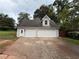 Three car garage with white doors and a side entry door at 1098 Oakdale Ne Rd, Atlanta, GA 30307