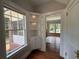 Hallway with built-in shelves leads to screened porch, allowing for seamless indoor-outdoor living at 1098 Oakdale Ne Rd, Atlanta, GA 30307