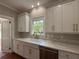 Bright kitchen with custom white cabinetry, farmhouse sink, marble countertops, and stainless steel appliances at 1098 Oakdale Ne Rd, Atlanta, GA 30307