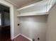 Bright laundry room with white built-in shelves and red-tiled floors at 1098 Oakdale Ne Rd, Atlanta, GA 30307