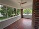 Enclosed porch with brick flooring, beadboard ceiling and walls, and a ceiling fan at 1098 Oakdale Ne Rd, Atlanta, GA 30307