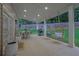 Covered patio with hanging swings, outdoor dining area, and grill at 280 Woods Creek Drive, Suwanee, GA 30024