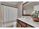 Bathroom featuring a shower with a white curtain and dark wood vanity with a white countertop and oval sink at 280 Woods Creek Drive, Suwanee, GA 30024