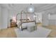 Spacious bedroom with tray ceiling, stylish lighting, and a seating area at 280 Woods Creek Drive, Suwanee, GA 30024