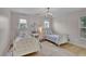 Charming bedroom with two white beds, hardwood floors, and a decorative chandelier at 280 Woods Creek Drive, Suwanee, GA 30024