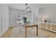 Elegant dining room with wainscoting, a long wooden table, and a modern chandelier at 280 Woods Creek Drive, Suwanee, GA 30024