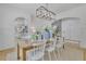 Elegant dining room with wainscoting, a long wooden table, and a modern chandelier at 280 Woods Creek Drive, Suwanee, GA 30024
