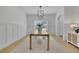 Elegant dining room with wainscoting, a long wooden table, and a modern chandelier at 280 Woods Creek Drive, Suwanee, GA 30024