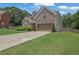 Charming two-story home featuring a manicured lawn, brick and stone accents, and a two-car garage at 280 Woods Creek Drive, Suwanee, GA 30024