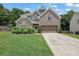 Charming two-story home featuring a manicured lawn, brick and stone accents, and a two-car garage at 280 Woods Creek Drive, Suwanee, GA 30024