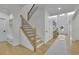 Bright foyer with hardwood floors, staircase with black metal railings, and ample natural light at 280 Woods Creek Drive, Suwanee, GA 30024