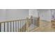 Upstairs hallway with hardwood floors, black metal railings and a seating area at 280 Woods Creek Drive, Suwanee, GA 30024
