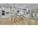 Bright, white kitchen features a large island with seating and pendant lighting and a large window with backyard view at 280 Woods Creek Drive, Suwanee, GA 30024