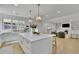 Well-lit kitchen flows into the living room, complete with a large island, seating and stainless steel appliances at 280 Woods Creek Drive, Suwanee, GA 30024