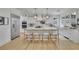 Bright, eat-in kitchen with white cabinets, marble countertops, stainless appliances and a large island at 280 Woods Creek Drive, Suwanee, GA 30024