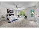 Bright bedroom featuring carpet, a ceiling fan, and a world map hanging above the comfortable bed at 3073 Waldrop Cir, Decatur, GA 30034