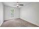 Empty bedroom featuring carpet, a ceiling fan, and natural light from the window at 3073 Waldrop Cir, Decatur, GA 30034