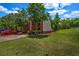Two story brick home featuring mature trees, a front lawn, and a driveway at 3073 Waldrop Cir, Decatur, GA 30034