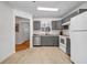Functional kitchen featuring stainless steel appliances, grey cabinets, and tile floors at 3073 Waldrop Cir, Decatur, GA 30034