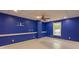 Finished basement with bright blue walls, white trim and baseboards, and a view to the outside at 5581 Fox Glove Ct, Douglasville, GA 30135