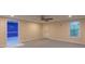 Spacious basement with a single window, ceiling fan, and access to unfinished utility area at 5581 Fox Glove Ct, Douglasville, GA 30135