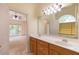Bathroom with dual sinks and a view into the main bedroom at 5581 Fox Glove Ct, Douglasville, GA 30135