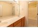 Bathroom boasting double sinks, wood cabinets and a shower-tub combo, illuminated with vanity lighting at 5581 Fox Glove Ct, Douglasville, GA 30135
