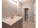 Well-lit bathroom featuring a modern vanity with sleek hardware and a storage closet at 5581 Fox Glove Ct, Douglasville, GA 30135