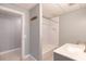 Bathroom featuring a neutral palette with a white shower-tub combo, sink and tile flooring at 5581 Fox Glove Ct, Douglasville, GA 30135