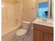Bright bathroom featuring a shower-tub combo and a toilet with updated vanity and mirror at 5581 Fox Glove Ct, Douglasville, GA 30135