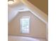 A naturally lit attic bedroom with windows and carpet flooring at 5581 Fox Glove Ct, Douglasville, GA 30135