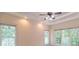 A bright bedroom with large windows and a ceiling fan, offering ample natural light and air circulation at 5581 Fox Glove Ct, Douglasville, GA 30135
