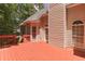 Exterior view of a two-story home with a large, stained wooden deck and access to the backyard at 5581 Fox Glove Ct, Douglasville, GA 30135
