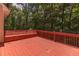 Expansive stained deck with built-in bench seating surrounded by a lush wooded area at 5581 Fox Glove Ct, Douglasville, GA 30135