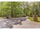 Long driveway leading to the home, framed by stone pillars and lush greenery at 5581 Fox Glove Ct, Douglasville, GA 30135