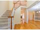 Spacious foyer with hardwood floors, staircase, and view into the living room at 5581 Fox Glove Ct, Douglasville, GA 30135