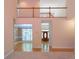 Bright two-story foyer with hardwood floors and stairs with railing, open to the dining room and front entrance at 5581 Fox Glove Ct, Douglasville, GA 30135