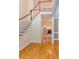 Grand foyer with hardwood floors and staircase with white railing at 5581 Fox Glove Ct, Douglasville, GA 30135
