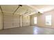 Spacious two-car garage with natural light from windows, and two automatic garage doors at 5581 Fox Glove Ct, Douglasville, GA 30135