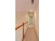 Upstairs hallway with a railing and neutral carpeting at 5581 Fox Glove Ct, Douglasville, GA 30135