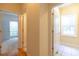 Hallway features access to a full bathroom with tiled flooring and additional access to a carpeted bedroom at 5581 Fox Glove Ct, Douglasville, GA 30135
