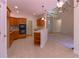 Open kitchen featuring tile floors, wooden cabinetry, modern appliances, and views of the living and dining areas at 5581 Fox Glove Ct, Douglasville, GA 30135