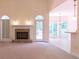 Spacious living room with carpet flooring, stone fireplace, and adjacent dining area flooded with natural light at 5581 Fox Glove Ct, Douglasville, GA 30135
